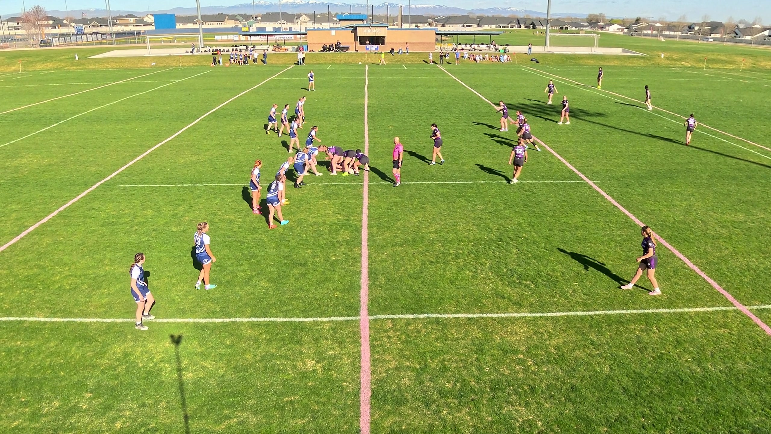 The same rugby play captured at extra zoom — a tighter view, closer to the ball