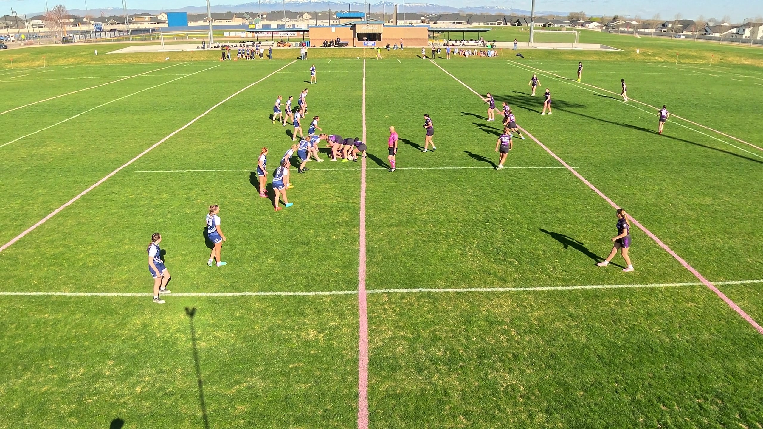 The same rugby play captured at standard zoom — a balanced framing of the field