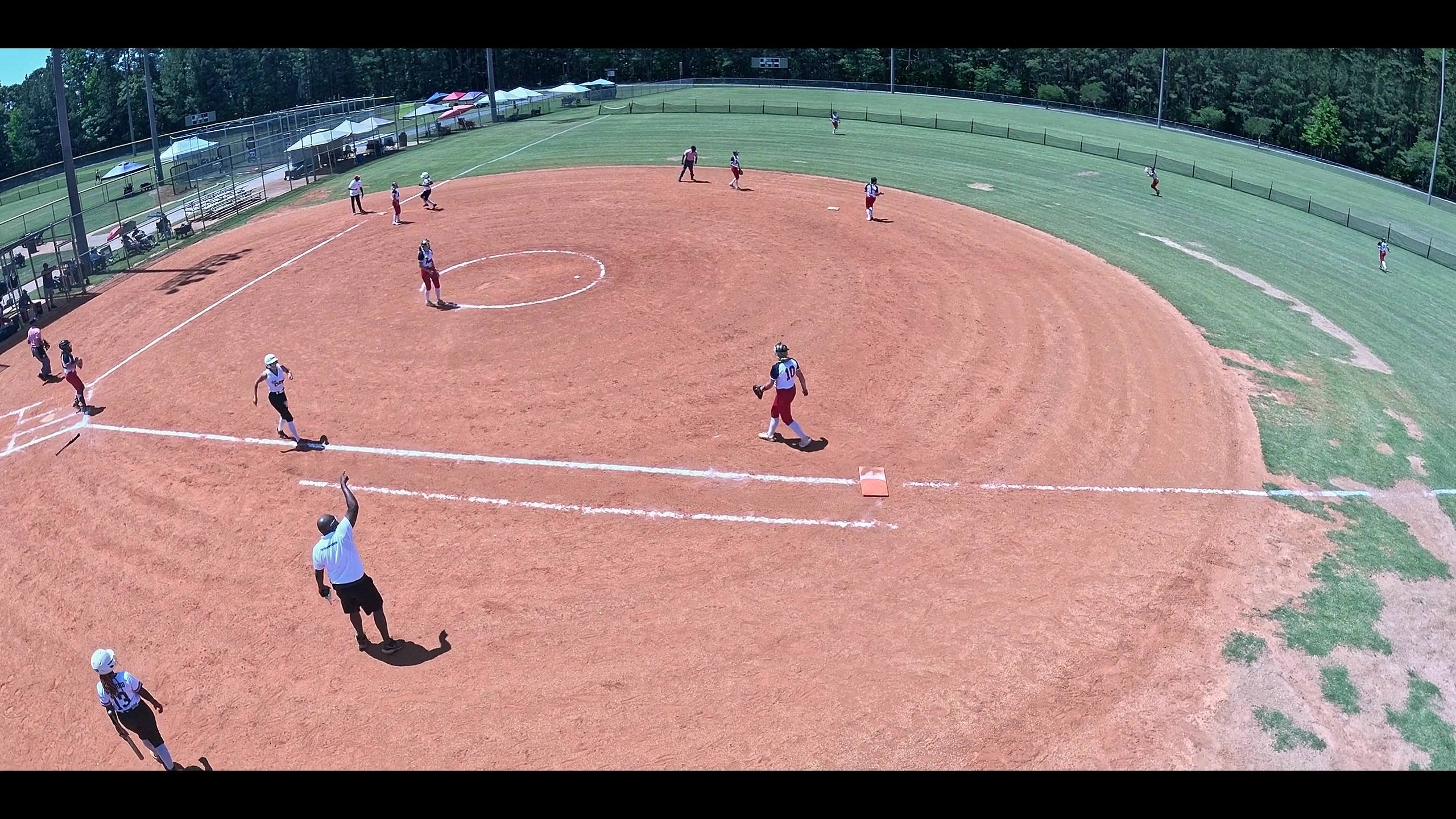 A wider frame following the ball into play while keeping the bases in view
