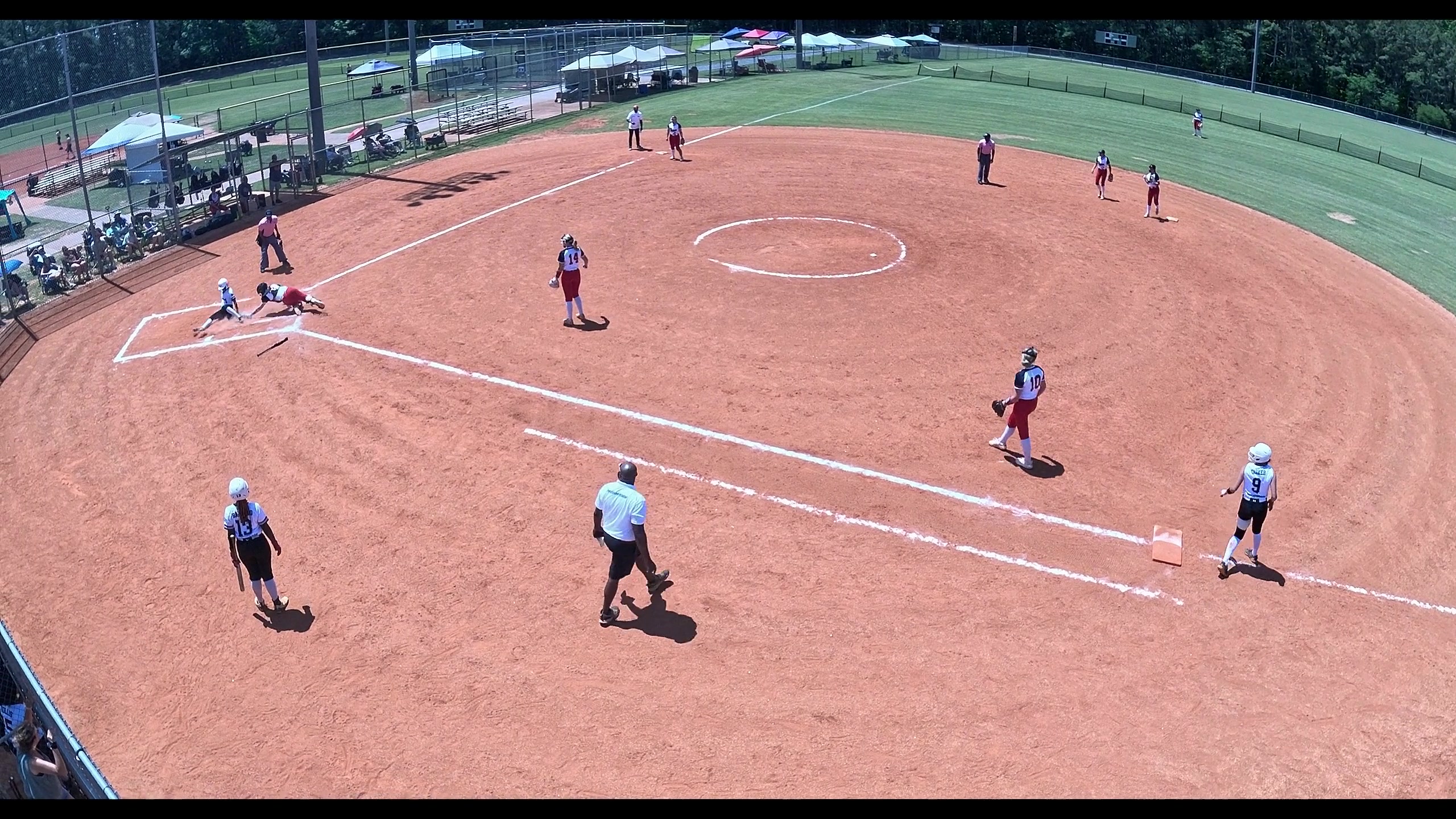 The frame prioritizing the play at the plate as a runner breaks for home